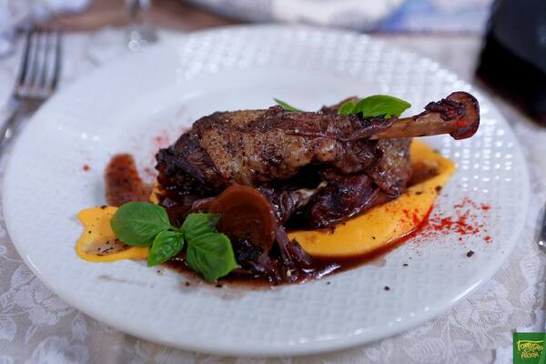 Rooster in wine with pumpkin puree